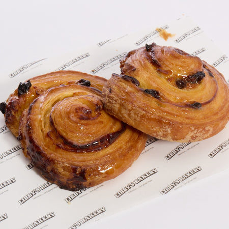 two of Libby's bakery gluten free pain aux raisins on white background