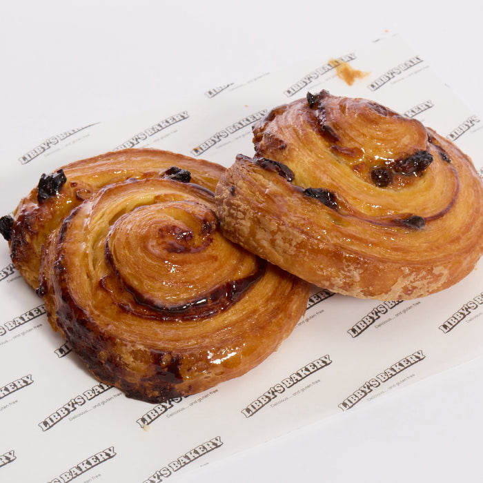 two of Libby's bakery gluten free pain aux raisins on white background