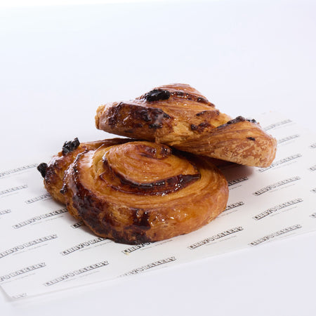 Two libbys pain aux raisins with on a Libbys paper with a white background