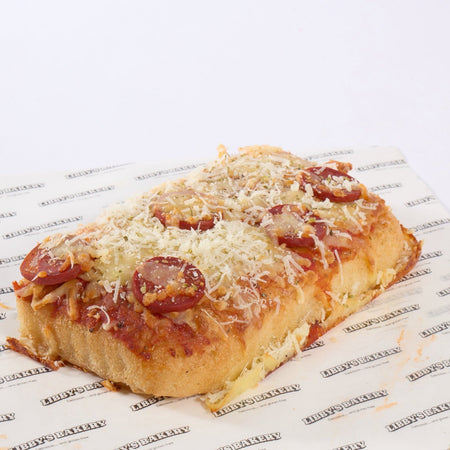 Gluten free foccacia pizza with pepperoni on a white background