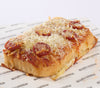 Slice of gluten free pepperoni foccacia pizza on libbys branded paper