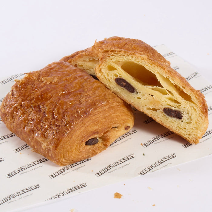 Two of Libbys bakers gluten free pain au chocolat one sliced in half