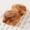 Two Libby's gluten free cinnamon buns on Libby's branded paper