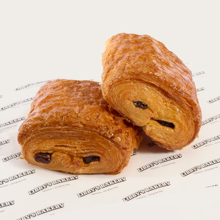 Two Libby's gluten free pain au chocolat on Libby's branded paper